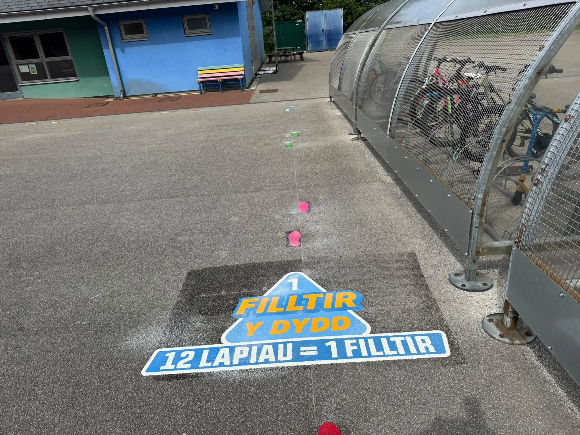 A daily mile running track and fitness markings on a school playground